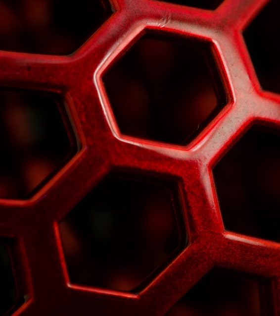 closeup-red-pattern-with-hexagon-holes 1-min